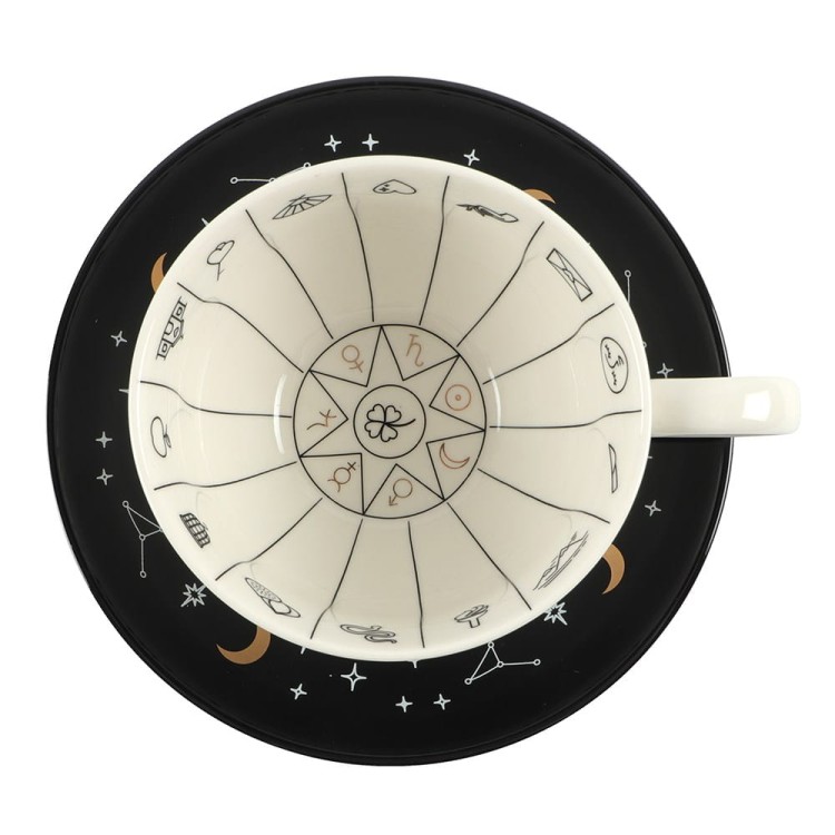 Filiżanka do wróżenia „The Fortune Teller” z czarnym spodkiem, złotymi symbolami wróżbiarskimi i ulotką z przewodnikiem po znaczeniu znaków.