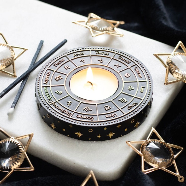 Astrology Wheel tealight holder na tle czarnego aksamitu i złotych ozdób